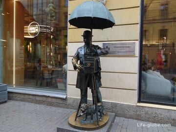 Monument to the photographer, Saint Petersburg (a man under an umbrella)